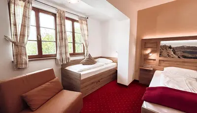 Ein Bett oder Betten in einem Zimmer der Unterkunft Hotel Garni Pension zur Wacht