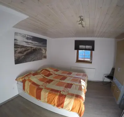 Ein Bett oder Betten in einem Zimmer der Unterkunft Haus Pistenblick