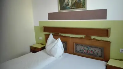 Ein Bett oder Betten in einem Zimmer der Unterkunft Pension Restaurant Meran