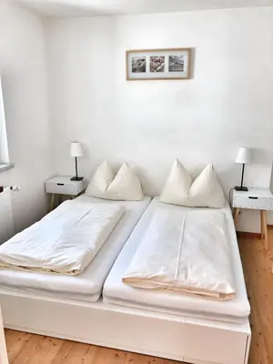Ein Bett oder Betten in einem Zimmer der Unterkunft Hubertus Dependance