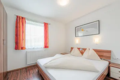 Ein Bett oder Betten in einem Zimmer der Unterkunft Alpenjuwel Appartements