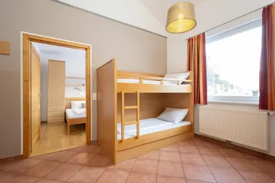 Ein Bett oder Betten in einem Zimmer der Unterkunft Apartmentdorf Flößerstube