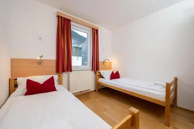 Ein Bett oder Betten in einem Zimmer der Unterkunft Apartmentdorf Flößerstube