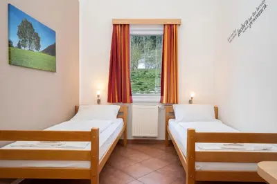 Ein Bett oder Betten in einem Zimmer der Unterkunft Apartmentdorf Flößerstube