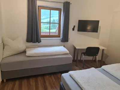 Ein Bett oder Betten in einem Zimmer der Unterkunft Ferienwohnung Schupfer - Free Parking, Seenähe & 5 Skigebieten