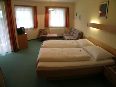 Ein Bett oder Betten in einem Zimmer der Unterkunft Hotel Tischlbergerhof