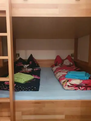 Ein Bett oder Betten in einem Zimmer der Unterkunft Höss-Alpin-Lodge