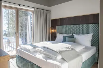 Ein Bett oder Betten in einem Zimmer der Unterkunft KAUZ - Design Chalets inkl Lungau Card