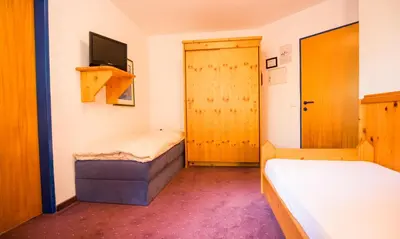 Ein Bett oder Betten in einem Zimmer der Unterkunft Hotel Enzian by Alpeffect Hotels