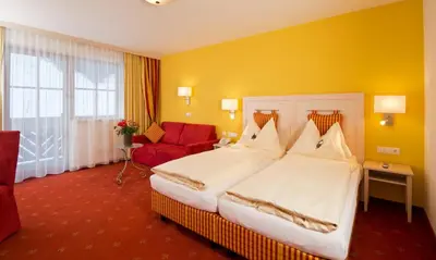 Ein Bett oder Betten in einem Zimmer der Unterkunft Hotel Enzian by Alpeffect Hotels