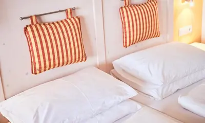 Ein Bett oder Betten in einem Zimmer der Unterkunft Hotel Enzian by Alpeffect Hotels