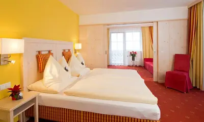 Ein Bett oder Betten in einem Zimmer der Unterkunft Hotel Enzian by Alpeffect Hotels