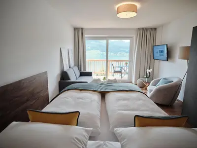 Ein Bett oder Betten in einem Zimmer der Unterkunft SEE Moment Appartements ADULTS ONLY
