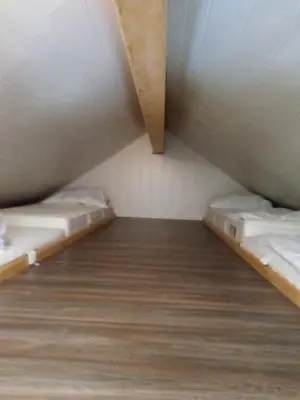 Ein Bett oder Betten in einem Zimmer der Unterkunft Ferienhaus Alpengarten