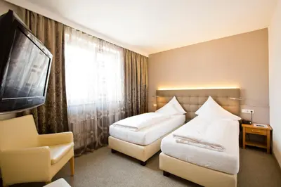 Ein Bett oder Betten in einem Zimmer der Unterkunft Stadthotel Goldenes Schiff