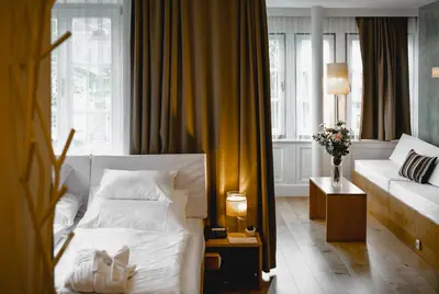 Ein Bett oder Betten in einem Zimmer der Unterkunft Seehotel Brandauer's Villen