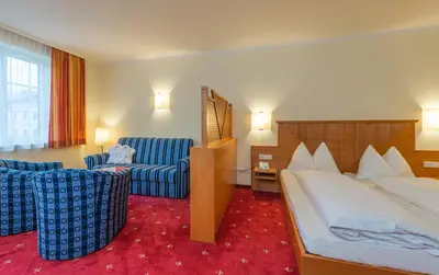 Ein Bett oder Betten in einem Zimmer der Unterkunft Posthotel Radstadt