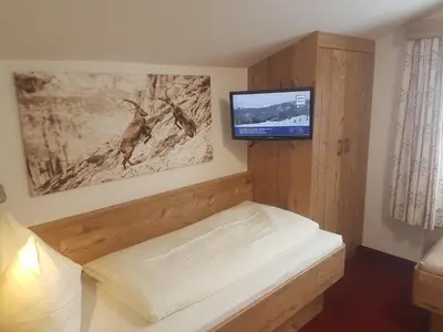 Ein Bett oder Betten in einem Zimmer der Unterkunft Hotelpension Oberauer Wagrain