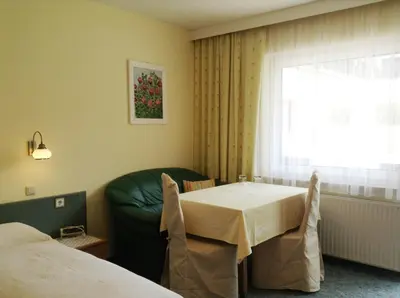 Ein Bett oder Betten in einem Zimmer der Unterkunft Parkpension Billroth