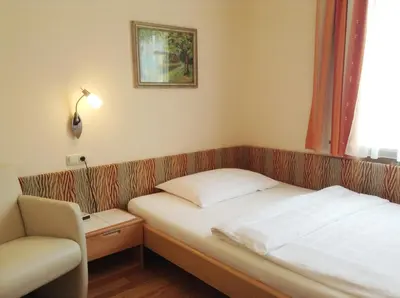Ein Bett oder Betten in einem Zimmer der Unterkunft Parkpension Billroth