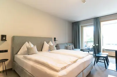 Ein Bett oder Betten in einem Zimmer der Unterkunft Apart & Suiten Hotel WEIDEN