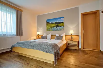 Ein Bett oder Betten in einem Zimmer der Unterkunft Alpendorf Hotel Stern