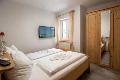 Ein Bett oder Betten in einem Zimmer der Unterkunft Apartmenthaus HAUS Gipfelglück Apartment KUAFSTOA