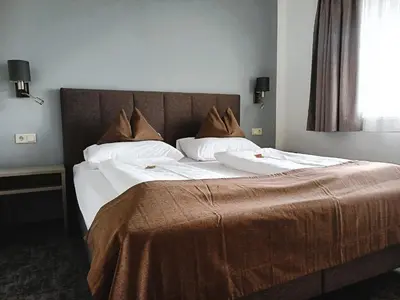 Ein Bett oder Betten in einem Zimmer der Unterkunft Ferienhotel Gewürzmühle