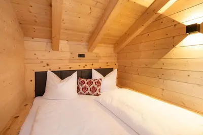 Ein Bett oder Betten in einem Zimmer der Unterkunft Holzlodge Chalets Nähe Obertauern