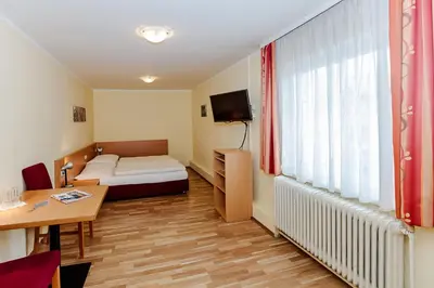 Ein Bett oder Betten in einem Zimmer der Unterkunft Hotel Denk Bed & Breakfast
