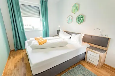 Ein Bett oder Betten in einem Zimmer der Unterkunft Sunny Aich by Alpenidyll Apartments