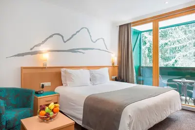 Ein Bett oder Betten in einem Zimmer der Unterkunft Alpine Club Apartement für 6 Personen