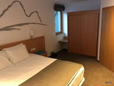 Ein Bett oder Betten in einem Zimmer der Unterkunft Alpine Club Apartement für 6 Personen